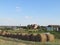 Hay in rolls with background of village houses