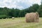 Hay rolls in a mown meadow on hill