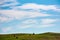 Hay stacks on hillside under the beautiful sky