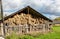 Hay storage with harvested bales of hay for cattle. Agricultural barn canopy with bales hay