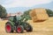 Hay tractor stacking hay bales