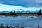 Haybales sitting by a frozen pond. Sibbald Creek Trail, Alberta, Canada