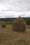 Haymaking season in Ukrainian Carpathian villages, women work in the field, throwing and raking hay by hand in the field