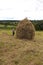 Haymaking season in Ukrainian Carpathian villages, women work in the field, throwing and raking hay by hand in the field