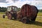 Haymaking time, round baling hay and farming tractor in farmland