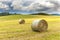 Haystack agriculture field landscape. Agriculture field hay stacks.Mown meadow with blue sky and clouds. Agricultural landscape in