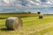 Haystack agriculture field landscape. Agriculture field hay stacks.Mown meadow with blue sky and clouds. Agricultural landscape in