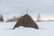 A haystack in deep snow, a rural landscape