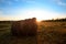 Haystack on farmland with blue cloudy