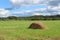 Haystack in a gentle meadow in the summer.