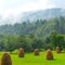 Haystack on grassland hill on foreground