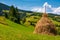 Haystack on a grassy hill on a summer day