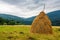 Haystack near orchard on hillside