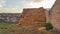 Haystack next to the barn. Stacked straw bales of hay. Square haystack under the open sky. Animal feed. Agricultural background.