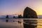 Haystack Rock at dusk, iconic natural landmark of the Oregon Coast, Cannon Beach, USA