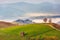 Haystack on rural fields in foggy mountainous area