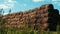 Haystacks on farming field agricultural farm. Bales hay stacks