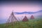 Haystacks in a misty valley