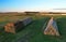 Haystacks near farm with cows and pigs. Hay in rolls at cowsheds. Haystack for Animal husbandry. Hay bale in Agriculture. Farm