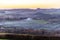 The haze of wood fire smoke over a Cornish valley in autumn