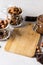 Hazelnut Almond and Chocolate Cream Chocolate Bar Glass Jars with Hazelnuts Almonds and Chocolate Gray Background Vertical