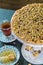 Hazelnut cake on table with tea and honey dipper