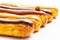 Hazelnut, caramel and chocolate French eclair pastry. Shallow depth of field with focus on the middle hazelnut one. white