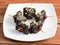 Hazelnut with chocolate flavored betel leaf on ice stuffed with cherry known as Hazelnut chocolate paan.