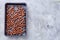 Hazelnut on cooking tray over white background, selective focus, shallow depth of field, top view.