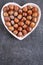 Hazelnut harvest. Nut in a heart plate on on slate background. Hazelnut on the slate.