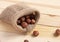 Hazelnut heap on wooden table, sackcloth full of nuts, selective focus. Zero waste concept