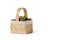 Hazelnut lies in a wooden basket on a white isolated background. Unpeeled hazelnuts in shell and green leaves