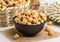 hazelnut served in a bowl isolated on napkin side view of nuts on grey background