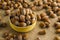 Hazelnuts in bamboo bowl on the jute fabric surface