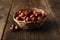 Hazelnuts in basket on brown wooden background