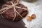 Hazelnuts in the peel and oatmeal cookies on brown table.  Oatmeal cookies  with crack pattern and nuts on  table in rustic style