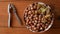 Hazelnuts in porcelain bowl on rustic wooden background. Raw fresh homegrowing nuts from house garden, weight loss diet