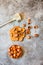 Hazelnuts in the shell in a small wooden and nutcracker. On a gray background. Top view