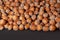 Hazelnuts. Stack of hazelnuts. Food background. Hazelnut on darck background