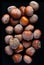 Hazelnuts . Whole nuts, shelled. Ground hazelnuts and hazelnut brittle. Macro photo, close up, top view, isolated, on black