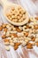 Hazelnuts in a wooden spoon on a wooden background