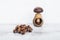 Hazelnuts on wooden table with one nut in mushroom-shaped nut-cracker