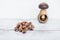 Hazelnuts on wooden table with one nut in mushroom-shaped nut-cracker