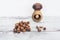 Hazelnuts on wooden table with one nut in mushroom-shaped nut-cracker