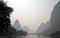 A hazy scene along the Li River between Guilin and Yangshuo in Guangxi Province, China