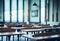 Hazy schoolroom with vacant tables and chairs and no pupils.