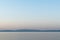 Hazy silhouettes of islands Brac and Hvar across Adriatic sea during summer morning captured from Croatia coast