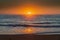 Hazy sunrise seascape with low swell