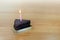 HBD cake Chocolate dark 1 piece crescent, Blowing Cake Candle brown, Happy Birthday one year anniversary on table wood