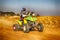 HD- Quad Bike kicking up trail of dust on sand track during rall